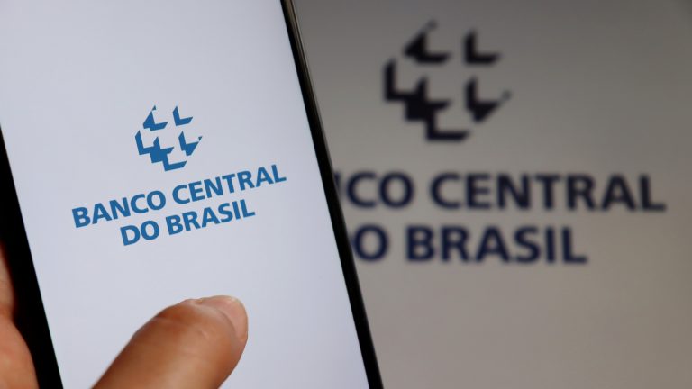 Aplicativo do Banco Central do Brasil em frente a logo da autarquia