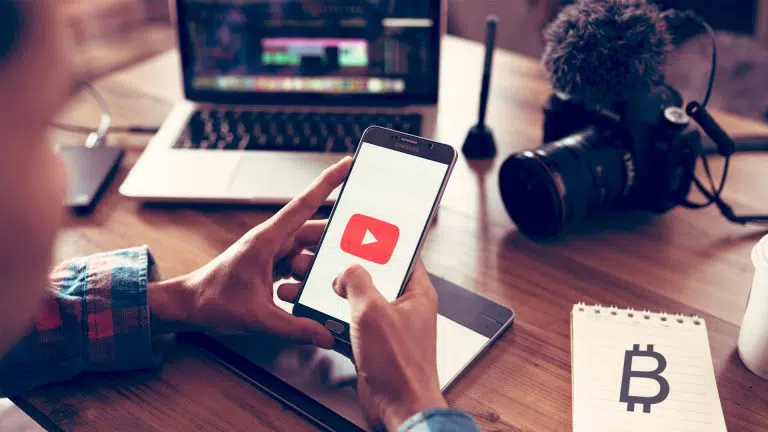 Pessoa com celular no YouTube